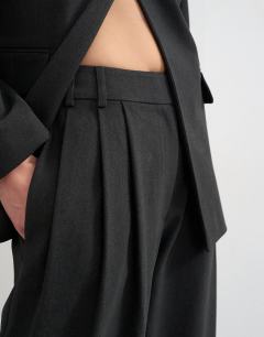 Model wearing Triple pleat trouser in black