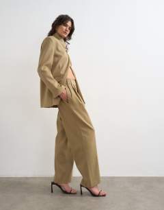 Model wearing Triple pleat trouser in neutral