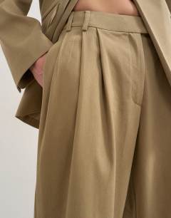 Model wearing Triple pleat trouser in neutral