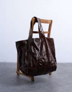 Model wearing Troy crinkle tote bag in chocolate