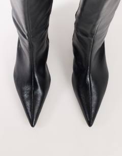 Model wearing Troy kitten heel knee high boot in black