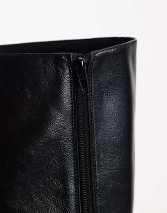 Model wearing Troy kitten heel knee high boot in black