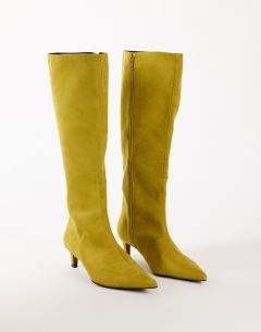 Model wearing Troy kitten heel knee high boot in olive faux suede