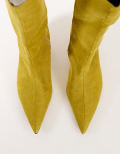 Model wearing Troy kitten heel knee high boot in olive faux suede