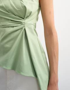 Model wearing Tuck side asym hem top in sage