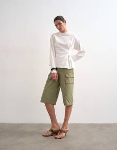 Model wearing Tuck waist long sleeve tee in ivory