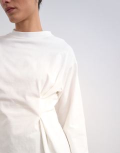 Model wearing Tuck waist long sleeve tee in ivory