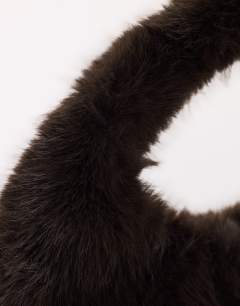 Model wearing Tully large faux fur shoulder bag in chocolate