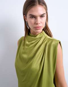 Model wearing Tunic tuck sleeveless top in green