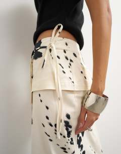 Model wearing Twill wrap tie detail maxi skirt in cow print