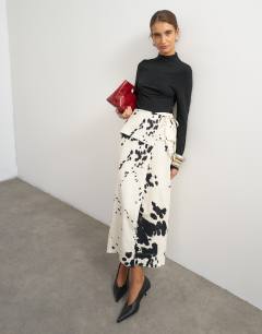 Model wearing Twill wrap tie detail maxi skirt in cow print