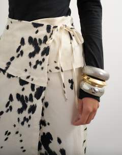 Model wearing Twill wrap tie detail maxi skirt in cow print