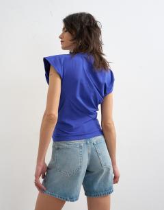 Model wearing Twist body top in cobalt blue