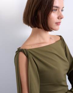 Model wearing Twist shoulder detail long sleeve top in brown