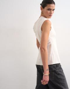 Model wearing Twist shoulder linen asymmetric top in ecru