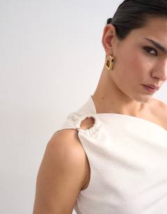 Model wearing Twist shoulder linen asymmetric top in ecru