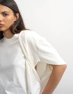 Model wearing Twist shoulder top in ivory