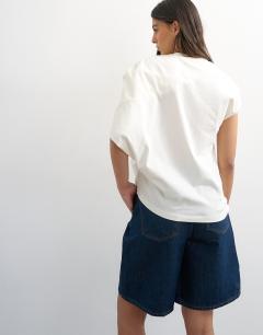 Model wearing Twist shoulder top in ivory