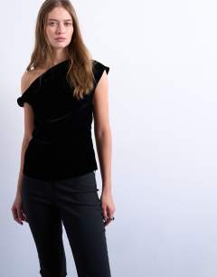 Model wearing Twist shoulder velvet top in black