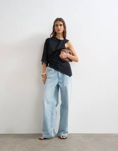 Model wearing Twist strap asymmetric top in black
