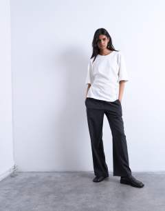 Model wearing Twisted detail t-shirt in ivory