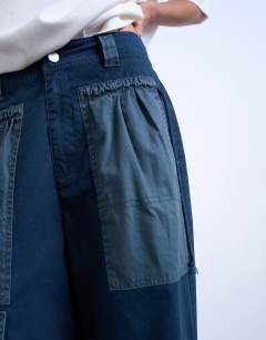 Model wearing Two toned cargo trousers with deep pockets in slate