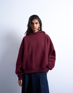Model wearing Ultimate hoodie in burgundy