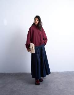 Model wearing Ultimate hoodie in burgundy