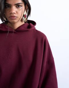 Model wearing Ultimate hoodie in burgundy