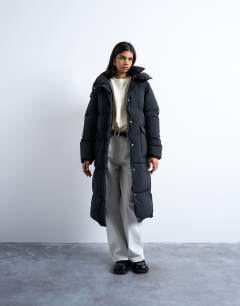 Model wearing Ultimate longline funnel neck puffer jacket in black