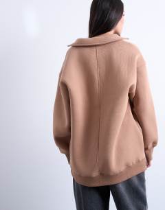 Model wearing Ultra long v-neck polo sweat in brown