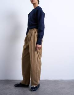 Model wearing Utility pintuck chino trouser in tan