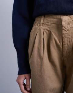 Model wearing Utility pintuck chino trouser in tan
