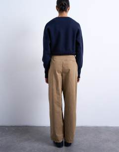 Model wearing Utility pintuck chino trouser in tan