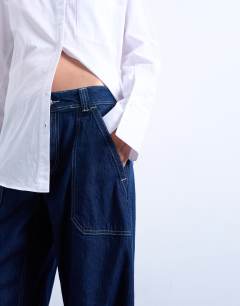 Model wearing Utility pocket barrel jean in indigo rinse