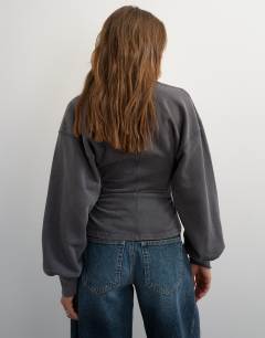 Model wearing V-neck cinch waist sweat in black