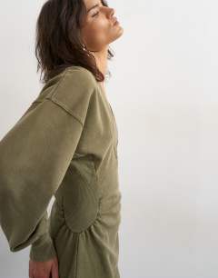 Model wearing V-neck cinch waist sweat mini dress in khaki