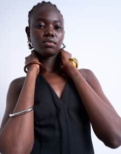Model wearing V neck clean placket structured mini dress in black