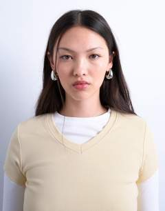 Model wearing V-neck double layer long sleeve top in buttermilk and ecru
