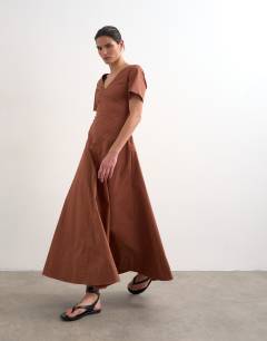 Model wearing V neck heavy seamed midi dress in rust