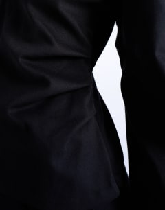 Model wearing V neck ovoid sleeve top in black