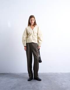 Model wearing V neck ovoid sleeve top in cream