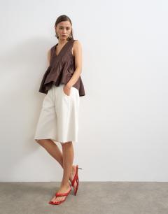 Model wearing V neck pintuck detail a line top in chocolate