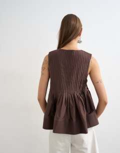 Model wearing V neck pintuck detail a line top in chocolate