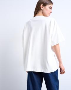 Model wearing V-neck premium interlock tee in ecru