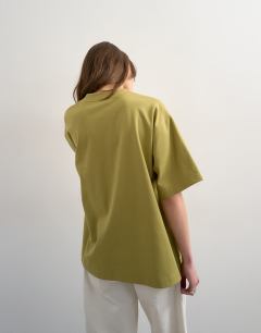 Model wearing V-neck premium interlock tee in khaki