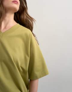 Model wearing V-neck premium interlock tee in khaki