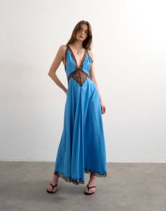 Model wearing V neck satin slip dress with chocolate brown contrast lace inserts in cornflower blue