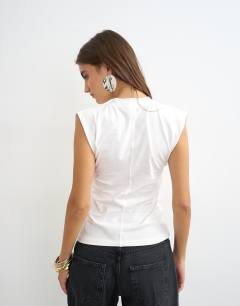 Model wearing V-neck structured waist top in ecru