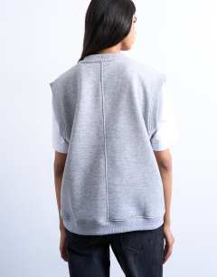 Model wearing V-neck sweat vest in grey marl